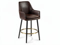 Brown faux leather bar stool with metal footrest and tapered legs